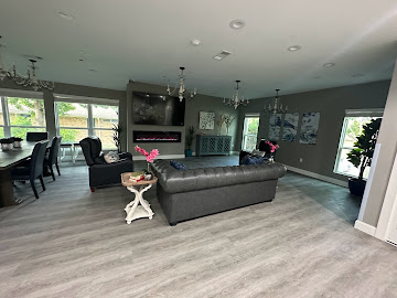 Remodeled open living room with linear fireplace, new flooring and modern lighting