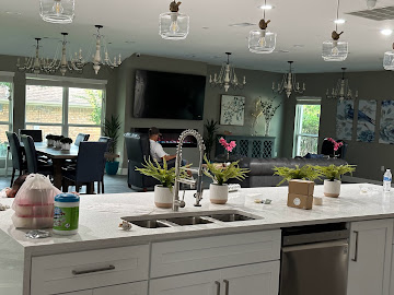 Open-plan kitchen remodel with quartz island, pendant lighting and custom cabinetry