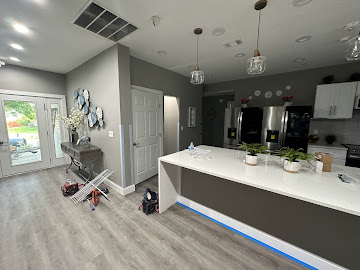 Renovated kitchen with waterfall island, stainless appliances and fresh interior paint