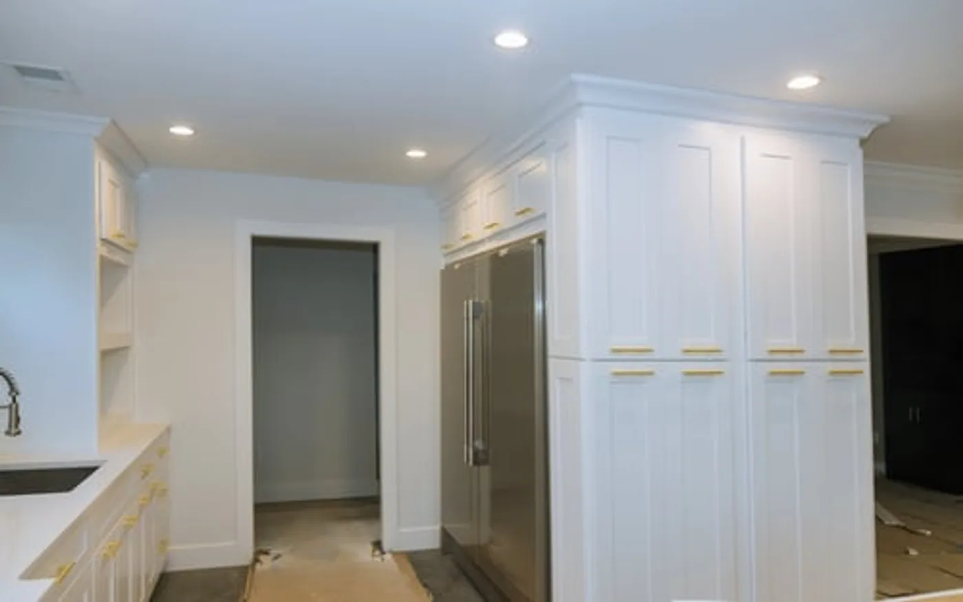 Custom white built-in cabinetry and trim carpentry in a bright interior hallway