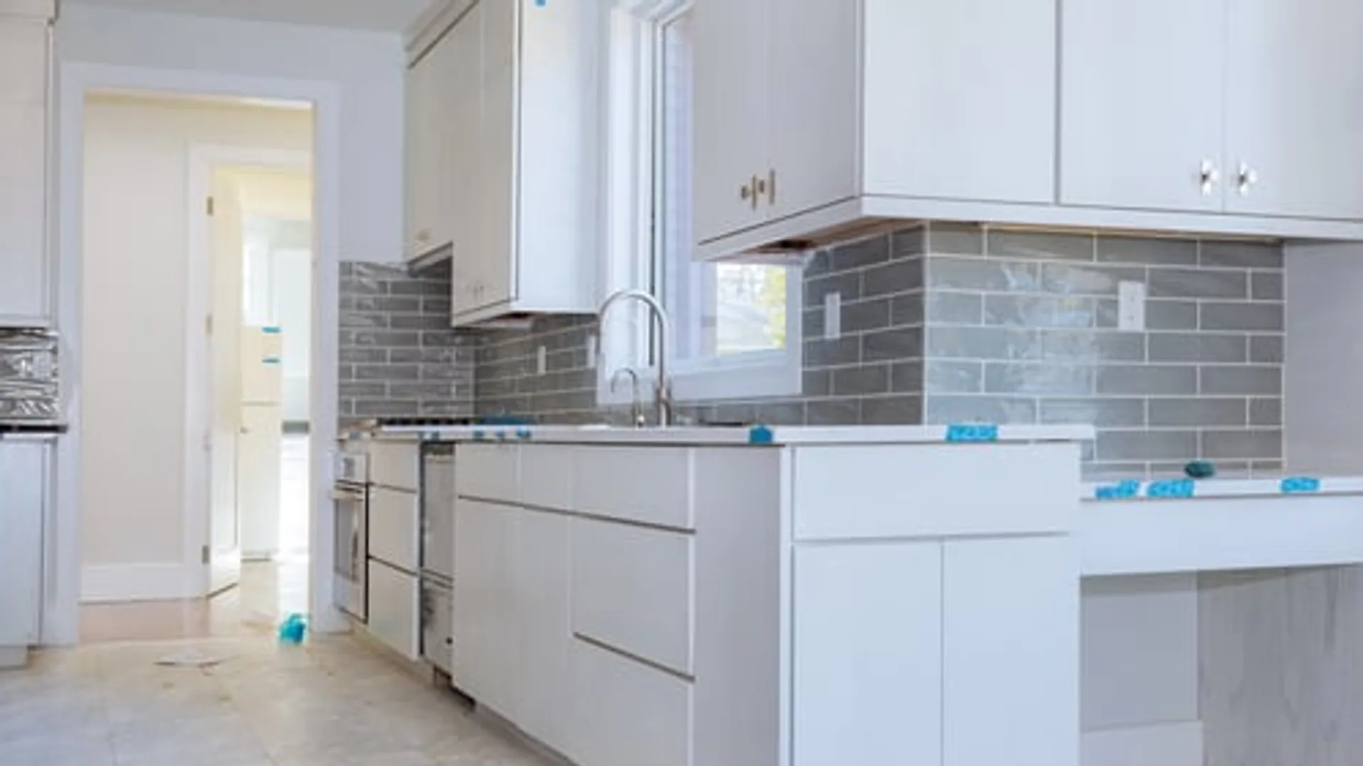 Bright, freshly finished kitchen interior with new white cabinetry